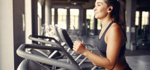 Girl in a gym. Woman on a racetrack. Lady in a black top.